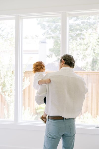 In-home newborn session of dad and toddler by a Dallas photographer