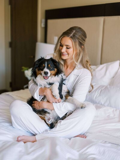 Bride shares first look with dog during destination wedding in Vail Colorado.
