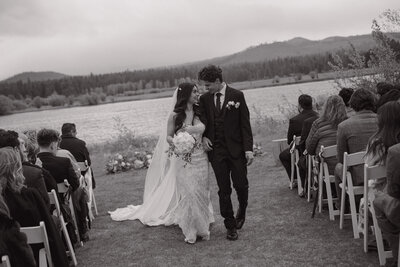 Newley wed couple walking back down looking at each other 
