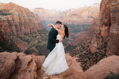 Utah Wedding Photographers capture mountain wedding bridal portraits with bride and groom smiling after destination elopement