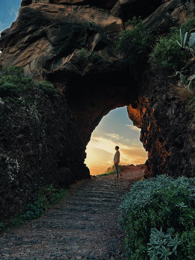woman standing underneath arch