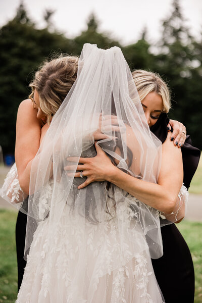 Bride hugging her bridesmaids