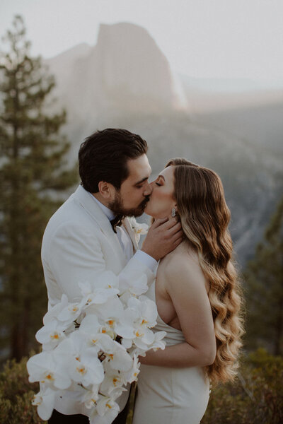 Bride and groom kiss at Glacier Point