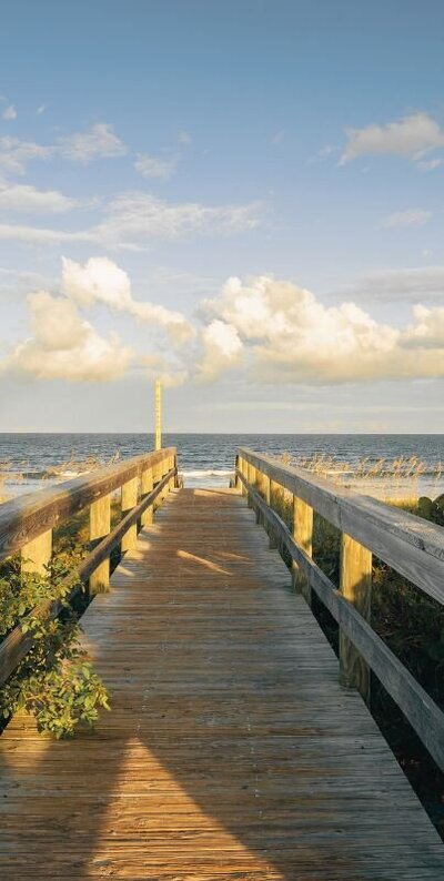wooden bridge leading out to a Florida beach