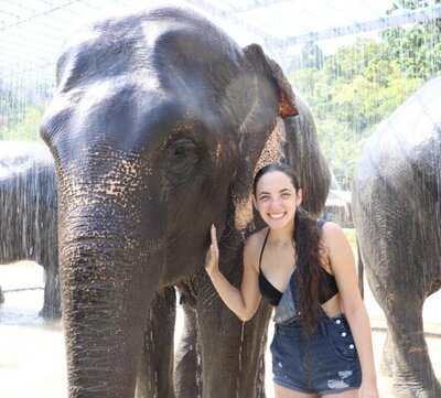 At Green Elephant Sanctuary in Phuket, me posing with an elephant while he is getting showered