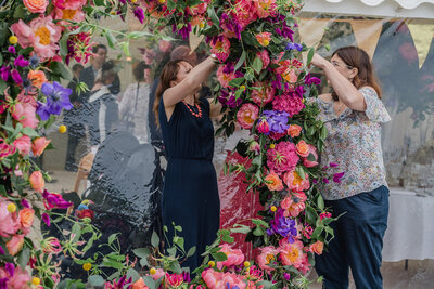 Anna and her team moving a moon gate into the marquee after the ceremony