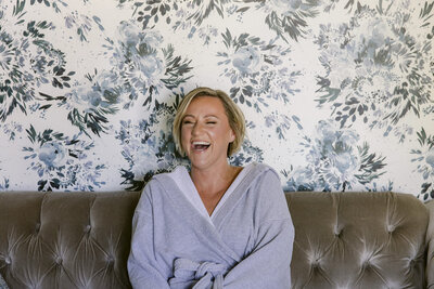 laughing bride to be in her robe before the wedding