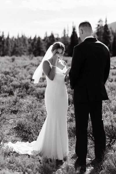 photo of bride and groom having their first look in a field taken by Documentary wedding photographer Jackson WY