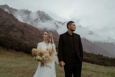 Couple embracing in the rain during a moody styled shoot in Queenstown, New Zealand.