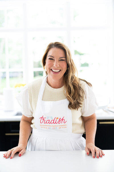 Woman with dark hair in white apron in her kitchen