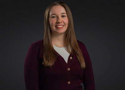 A professional headshot of a smiling woman with natural straight brown hair, captured by Atlanta Headshot Specialist Lynda Louis Photography