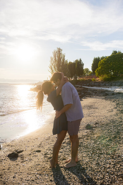 A couple embracing at beach after a romantic proposal