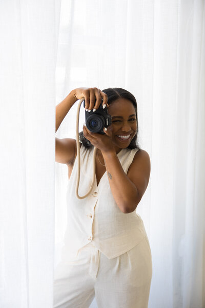London based Family and Wedding photographer in the studio with her camera.
