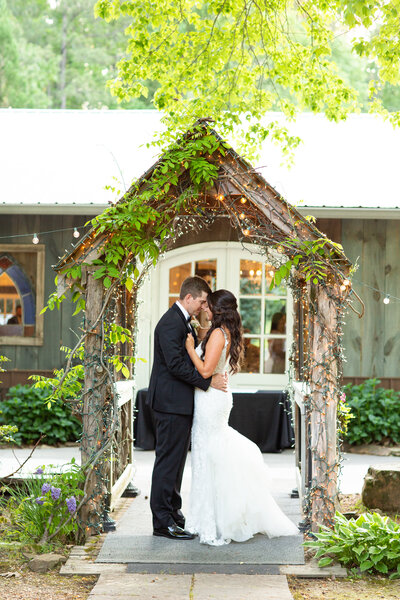 engaged couple posing by a stone church