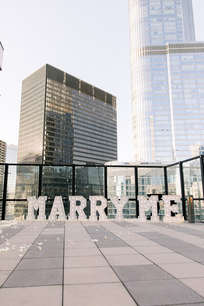 marry me sign on rooftop
