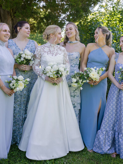 Organic loose bridal bouquet with white, tan, dusty rose and light blue flowers including roses, lisianthus and peonies, light greens