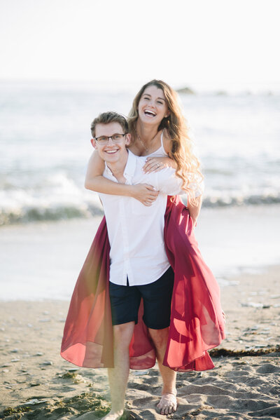 A couple standing on the beach with the sea in the background taken by  Cornwall Wedding Photographer and Devon Wedding Photographer Liberty Pearl