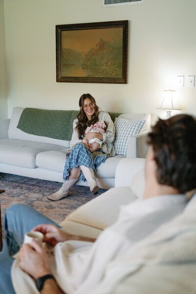 Family sitting on couches in home taken by Shelby Ann Photos, florida engagement photographers