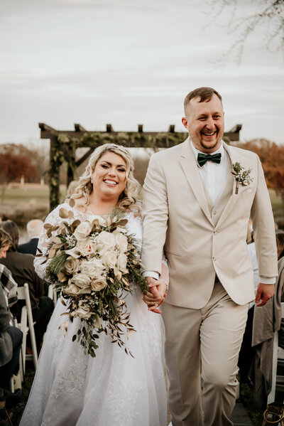 Bride and groom walking down the aisle