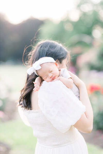 mama holding newborn baby in bed by ericka ana photography