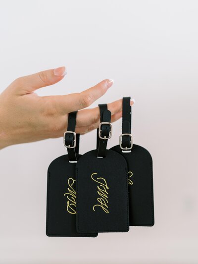 Black personalized luggage tags with gold foiled calligraphy