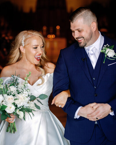 Bride and groom walk joyfully down the aisle during their Pittsburgh wedding ceremony, surrounded by guests