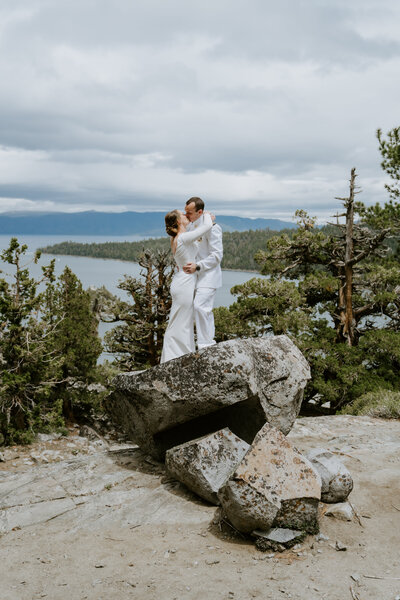 bride and groom kissing on mountain