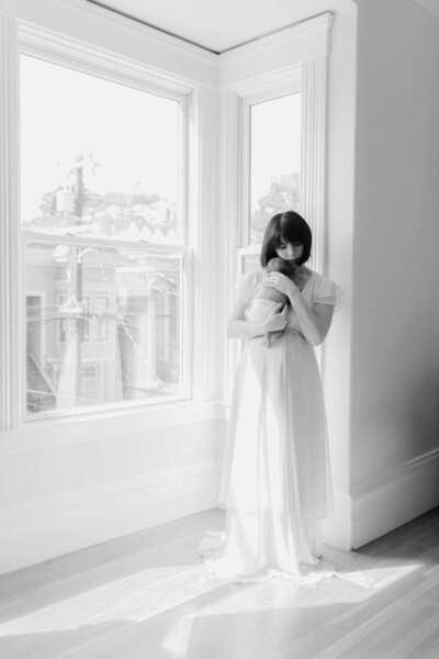 Timeless black-and-white portrait by a newborn photographer Bay Area in studio setting.