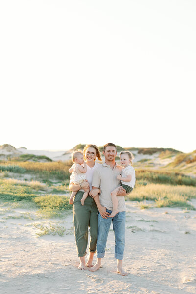 man holding girl spinning her around for an engagement session in austin texas by austin wedding photographer alyssa nikole