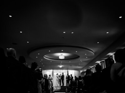 photo of bride looking at groom during speeches on wedding day