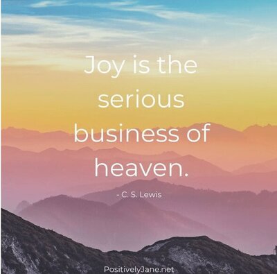 Joy is the serious business of heaven - quote with a beautiful sunset or sunrise from the mountains
