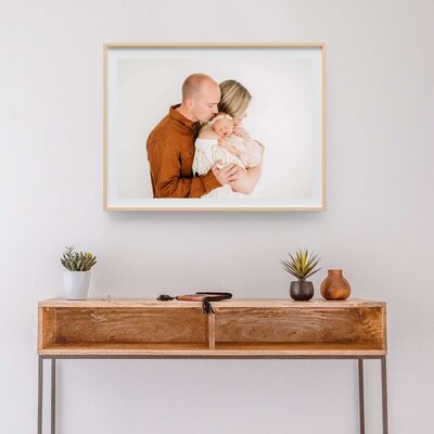 framed photo of family kissing newborn captured by Springfield MO newborn photographer The XO Photography