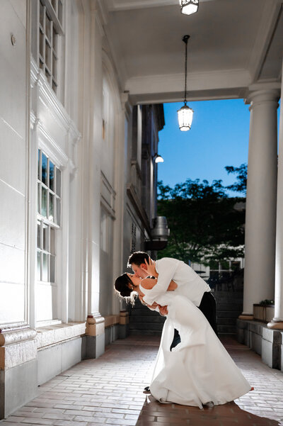 bride and groom end of the wedding night photo on the front patio columns of the george washington hotel