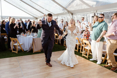 Bride embracing mom at wedding
