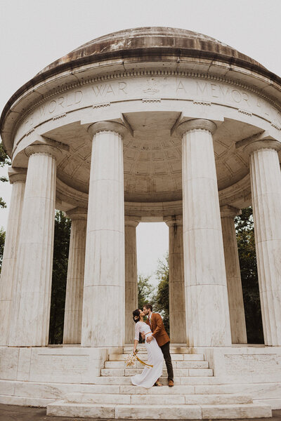 Bride and Groom kiss on steps of DC War Memorial