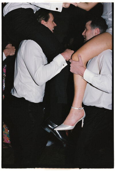Fun candid of evening guests dancing during the wedding party.
