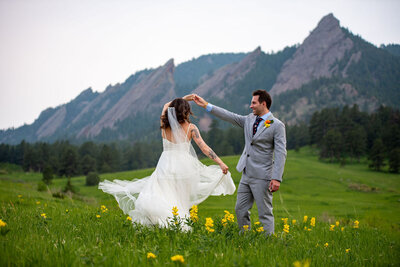 Bride and Groom laugh at a joke the groom made at the overlook to an alpine lake.