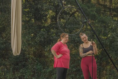 Aerialist Coach Lexis Potter teaching a aerial hammock lesson outside.