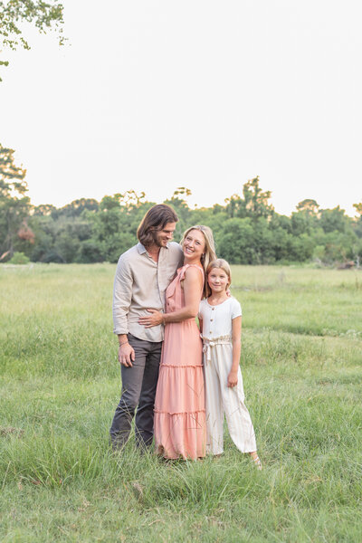Family posed together for pictures in a wooded park