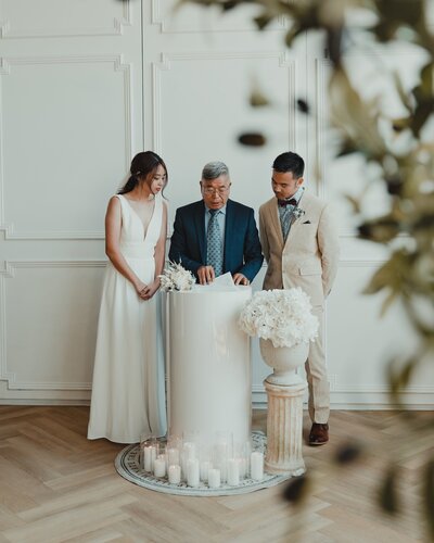 Bride and groom with wedding officiant