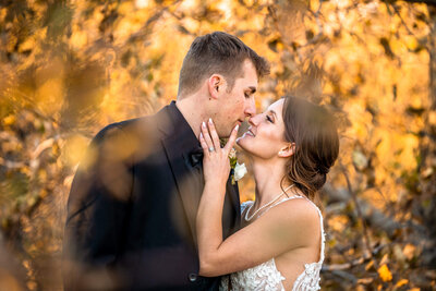 Bride and groom get in close for a kiss at their small wedding venue in Pennsylvania. Captured by Pittsburgh Wedding Photographer Michael Fricke Photography.