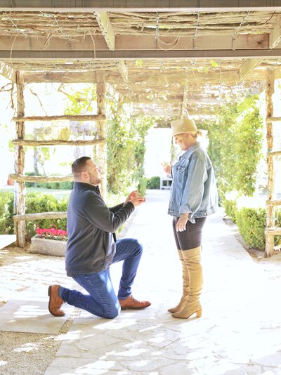 a man on one knee proposing to his girlfriend