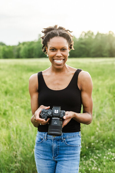 Lydia McRae smiling, holding her camera