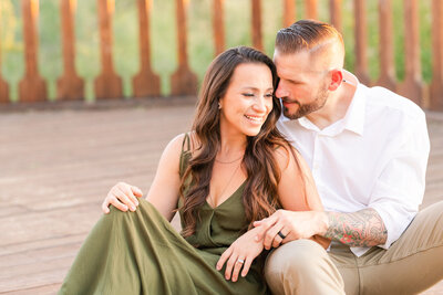 couple sitting together on wooden deck