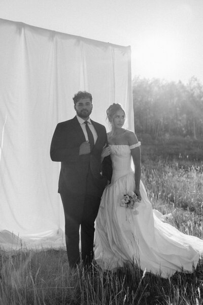 couple posing together with a backdrop.