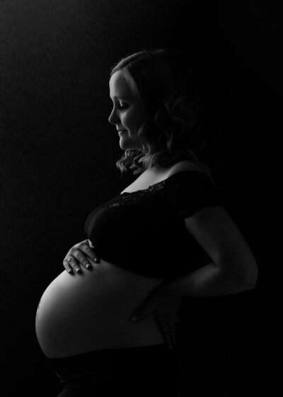 Ashland Oregon Maternity Photographer, low-key rim lighting of pregnant belly bump