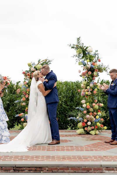 Rustic wedding ceremony decor featuring Leigh Florist's beautiful floral arrangements with wildflowers and earthy tones.