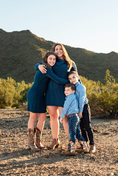 family of 5 posing and smiling for family photograph in Arizona