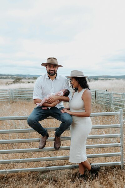 Young family with their newborn baby on their farm in Yass, NSW.