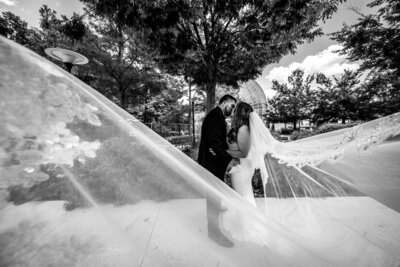 veil shot of a couple kissing in front of myriad gardens in oklahoma